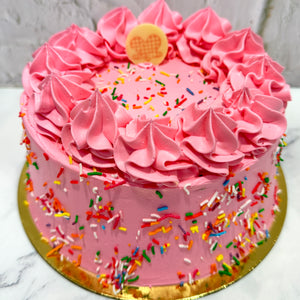 Pink cake with colourful sprinkles