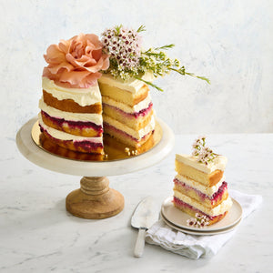 Slice of gluten-free naked Victoria sponge cake showing fluffy layers with cream and raspberry filling Bakealicious Sydney