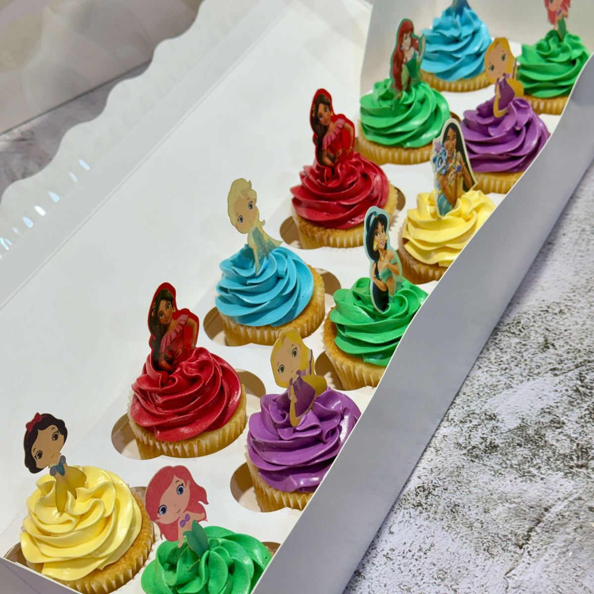 12 princess themed cupcakes with colourful buttercream