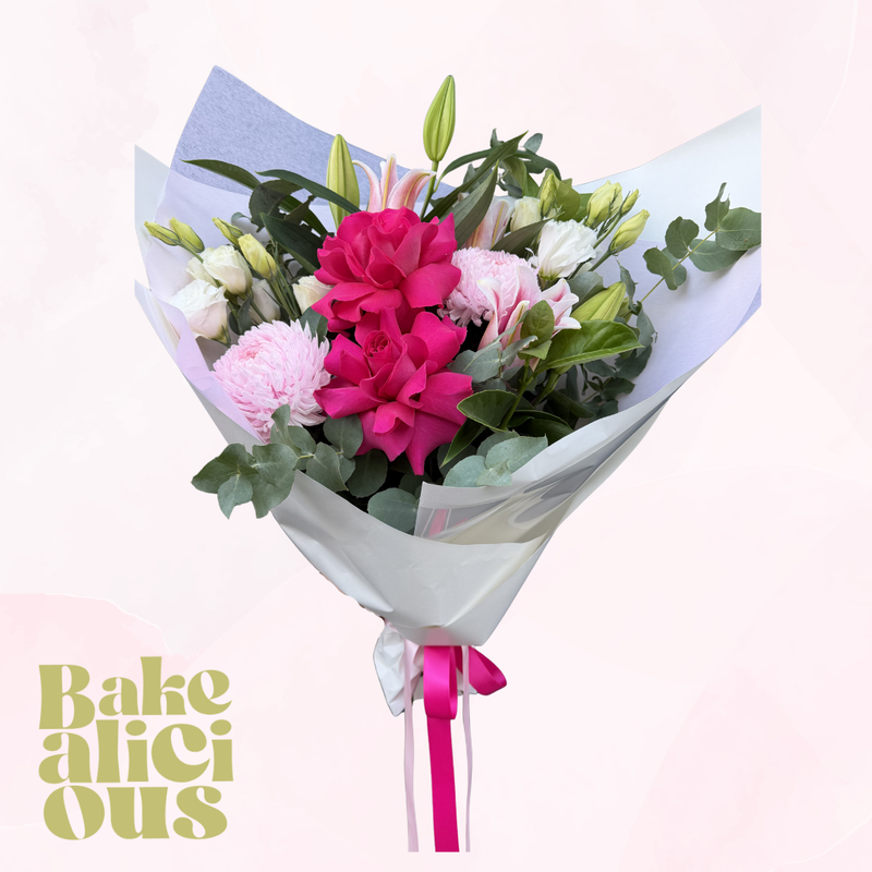 Bouquet of flowers with a pink ribbon on a light pink background, featuring the brand 'Bakealicious'.